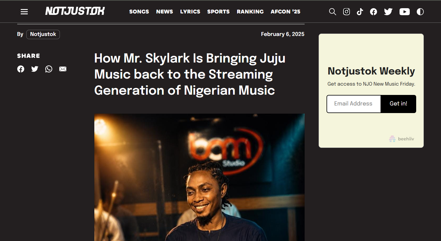 Mr Skylark smiling on stage, the photo run alongside the NotJustOk feature