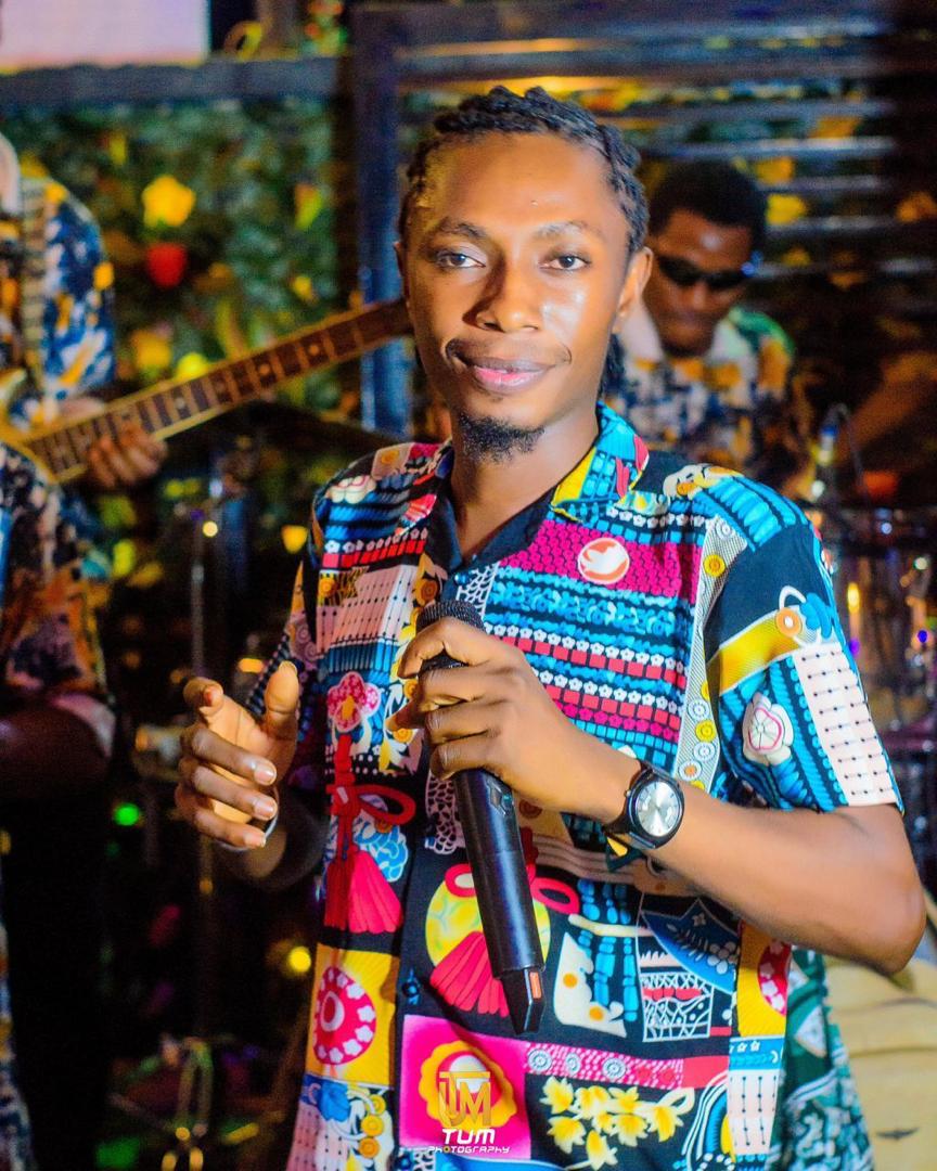 Mr Skylark performing live in a colorful traditional Ankara shirt