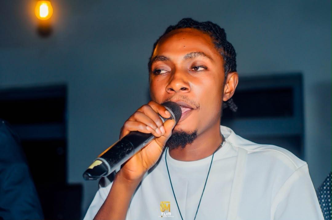 Mr Skylark singing into a microphone, close up