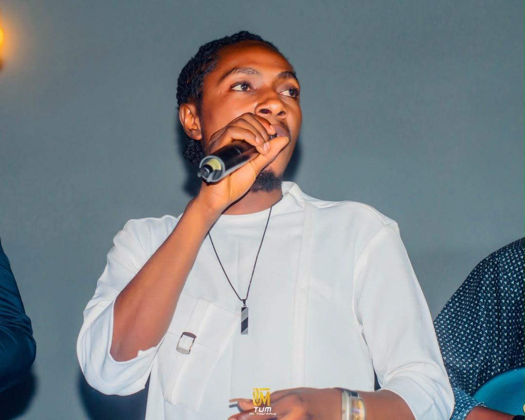 Mr Skylark singing with mic, looking upward